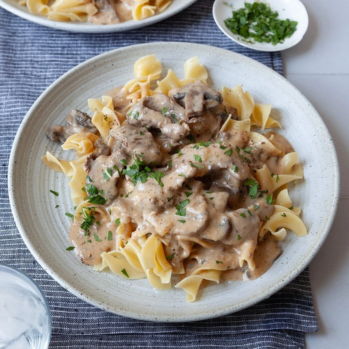 Beef stroganoff with mushrooms in creamy sauce over egg noodles