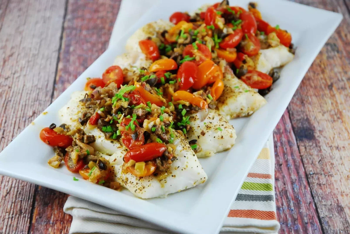 Seared local fish fillet topped with tomato and olive tapenade