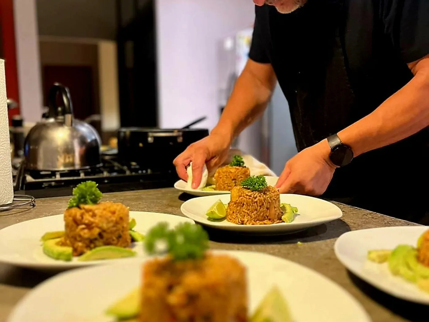 Chef Eddie plating molded rice with avocado for a private dinner