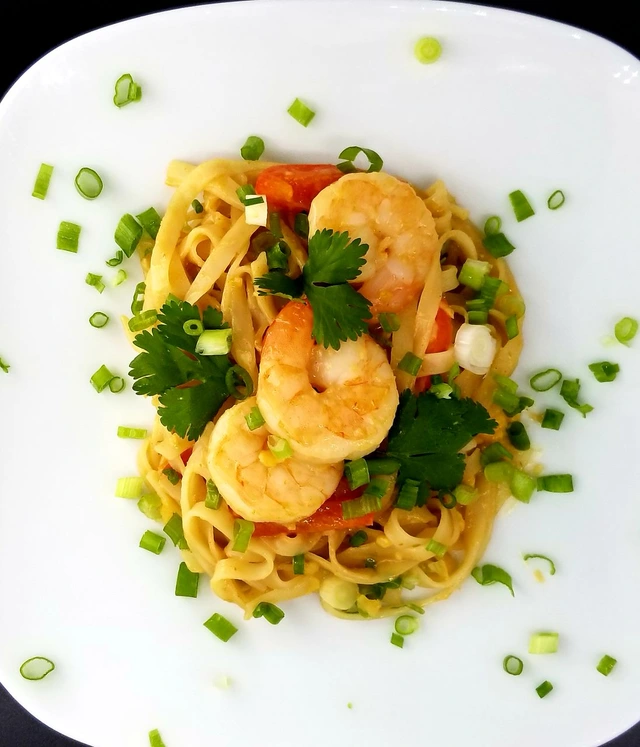 Creamy shrimp noodles finished with cilantro and green onion