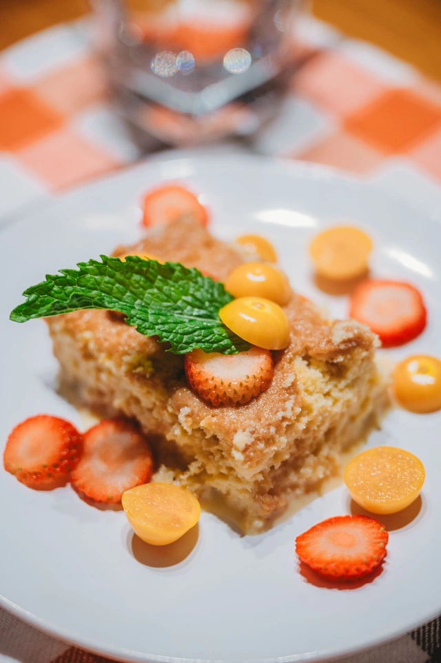 Tres leches cake with fresh strawberries, golden berries, and mint